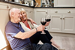Senior couple, floor and toast celebration, red wine or smile on anniversary with memory, love and bonding in home. Elderly woman, old man and glass for alcohol, relax and cheers for congratulations