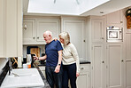 Kettle, coffee and happy senior couple in kitchen at home together in the morning for love, support or care in retirement. Tea, smile and elderly man and woman make hot drink with electric appliance