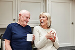 Coffee, funny and elderly couple in kitchen in home together in the morning for conversation, love and healthy connection. Tea, laughing and senior man and woman enjoying drink in mug in retirement.