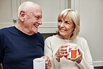 Senior, couple and coffee in kitchen with smile for retirement, break or beverage in the morning at home. Elderly, man and woman with tea for breakfast, happiness and bonding in house or apartment