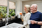 Coffee, happy and elderly couple in kitchen in home together in the morning for conversation, love and connection in retirement. Tea, smile and senior man and woman enjoying drink in mug or thinking