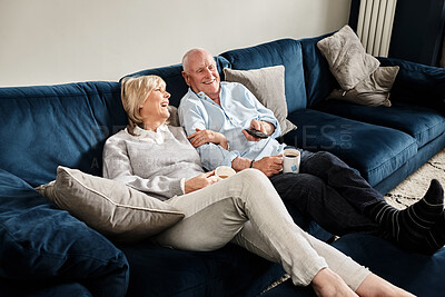 Buy stock photo Coffee, watching tv and retirement with a senior couple on a sofa in the living room of their home for entertainment. Tea, smile or relax with a happy elderly man and woman streaming in an apartment