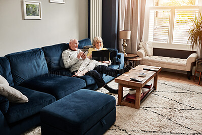 Buy stock photo Senior couple, sofa and relax with laptop and technology for streaming in retirement. Home, internet and movie, film and subscription for online content with a phone to browse social media for news