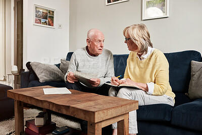 Buy stock photo Senior couple, documents and discussion for planning budget, investment assets or tax bills at home. Old man, woman and reading paperwork for insurance, mortgage loan or pension savings in retirement