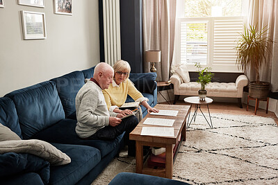 Buy stock photo Senior couple, documents and planning budget on sofa for investment, assets and bills at home. Man, woman and check paperwork for insurance information, mortgage loan and reading retirement savings 