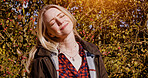 Autumn, nature and portrait of woman with peace, freedom and happiness outdoor in garden or backyard. Fall, trees and leaves in forest or person relax in park and breathing fresh air with sunshine