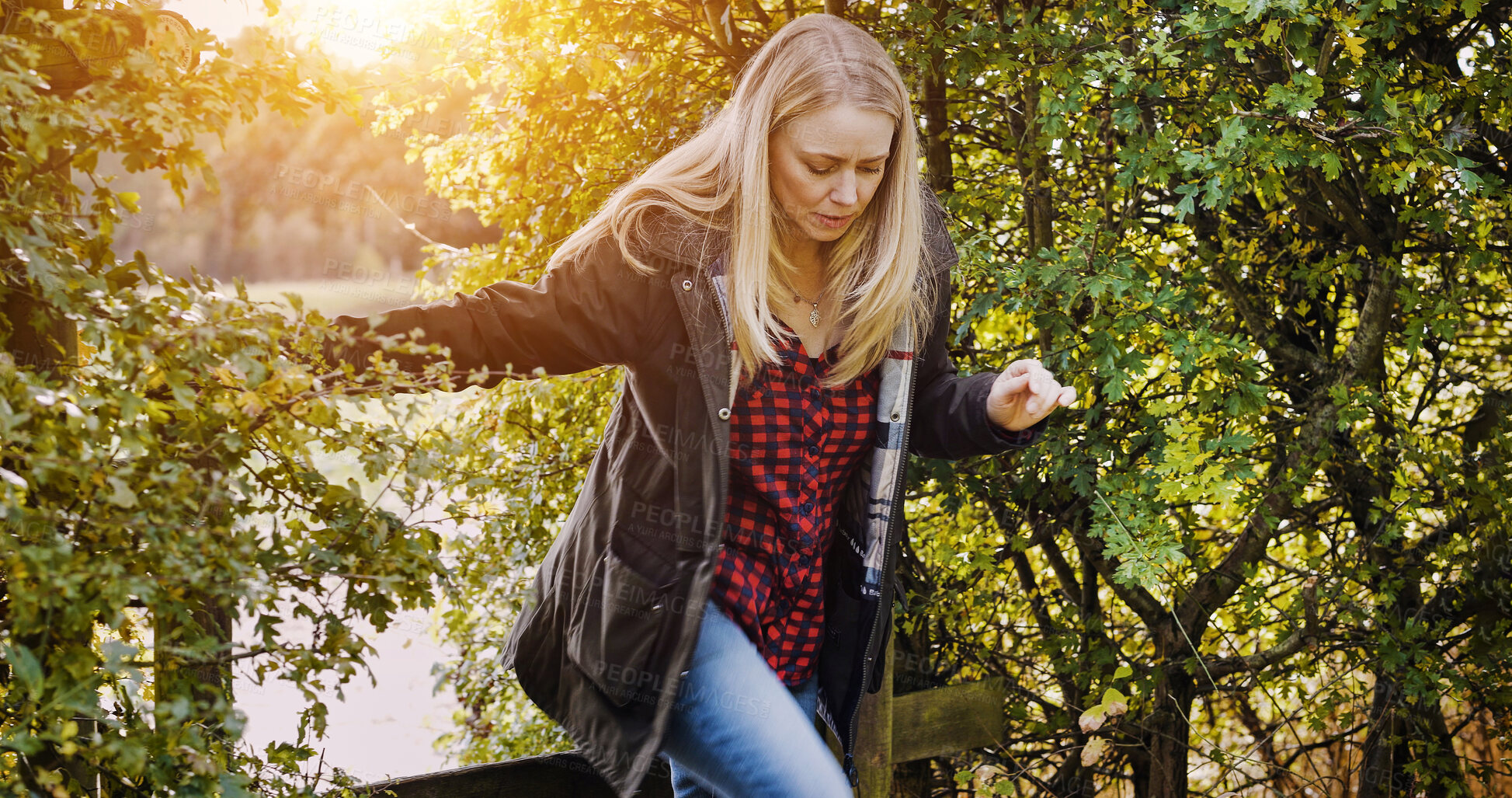 Buy stock photo Countryside, morning and woman by fence walking for wellness, fresh air and relax outdoors. Trees, spring  and person in field, meadow and farm for calm, peace and freedom in natural environment