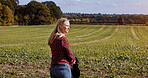 Woman, thinking and agriculture on field for farming, silage or nature in countryside. Female person, looking and doubtful expression on face with idea for landscaping, greenery and grass with vision