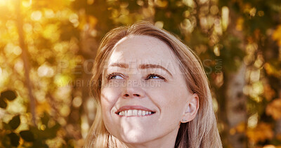 Buy stock photo Face, thinking and a happy woman in autumn garden for freedom, peace or inspiration from nature. Idea, smile and relax with a young person at a park in the afternoon during the colorful fall season