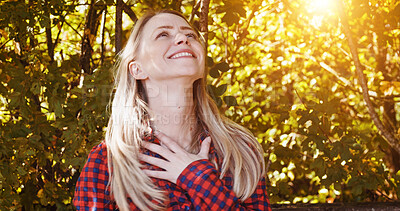 Buy stock photo Outdoor, thinking and woman with a smile, sunshine and summer break with happiness, relax and cheerful. Outside, forest and woods with girl, lens flare and model with wellness, environment and ideas