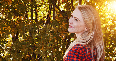 Buy stock photo Nature, happy and woman by trees with sunshine for wellness, fresh air and relax outdoors. Countryside, smile and person in forest, woods and morning for calm, joy and freedom in natural environment