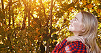 Outdoor, thinking and woman with happiness, sunshine and summer break with ideas, relax and cheerful. Outside, forest and woods with girl, lens flare and model with wellness, environment and nature