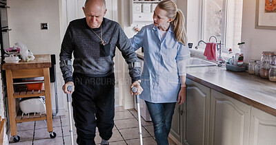 Buy stock photo Nurse help senior man in crutches in home kitchen, medical rehabilitation and recovery. Caregiver, person with a disability walk and support, health and physiotherapy, healing injury or accident pain