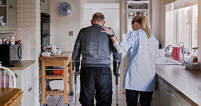 Buy stock photo Nurse support senior man in crutches in home kitchen, medical rehabilitation and recovery. Caregiver back, person with a disability walk and help, health and physiotherapy, healing injury or accident