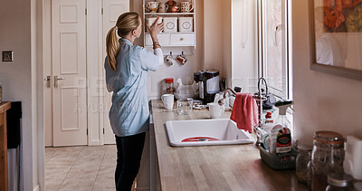 Buy stock photo Spring cleaning, kitchen and woman cleaner doing house work in a home for hygiene. Housekeeper, organize and packing dishes for chores and maintenance with care and wellness with maid working