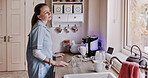 Thinking, apron and home with woman in a kitchen, ideas and bored with daydreaming, peaceful and calm. Person, girl and lady with solutions, problem solving and planning with decision and choice