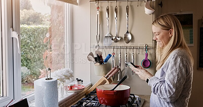 Buy stock photo Woman, phone and happy for cooking in kitchen with reading, search or video for recipe in home. Person, smartphone and smile with social media, blog or info for diet, nutrition or wellness in house