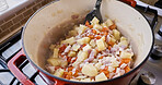 Food, cooking and ingredients in a pan on the stove of a kitchen in a home closeup from above. Health, diet or nutrition with a stew recipe in a skillet for lunch, supper and meal preparation