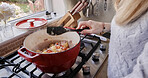 Woman, hand and food cooking closeup on stove pot for health nutrition meal, vegetables or potato. Female person, spoon and mix on gas device for dinner eating or home stew recipe, protein for hungry