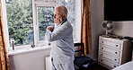 Elderly man stretching in home bedroom, relax and body health in the morning. Senior person exercise, wake up and flexible for wellness, fitness or training workout in retirement, apartment or house