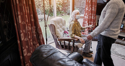 Buy stock photo Senior, couple and face mask in living room for virus protection or sick, compliance or health care. Old people, pandemic management for illness cooperation in home or marriage, empathy or quarantine