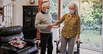Elderly, couple and help with walking stick for care, support or assistance on sofa in living room of home. Senior, man or woman with disability or cane in lounge of retirement with love and recovery