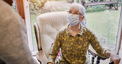 Buy stock photo Senior, woman and living room or mask protection for virus husband, compliance for health care. Old people, pandemic management for illness cooperation in home for marriage, empathy or quarantine