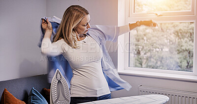 Buy stock photo Woman, wear clothes and ironing in home, laundry and housework in living room, apartment or house. Housekeeping service, chores and person with fresh shirt, maid cleaning or domestic work for hygiene