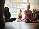 Woman, yoga and class for zen workout, spiritual wellness or stretching body together at gym or dojo. Calm female person or yogi group in easy pose for healthy exercise, fitness or mindfulness on mat