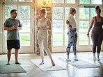 Talking, instructor or people in yoga class for support, conversation or body in studio together. Coach, woman teaching or group learning in pilates to start or relax for chakra energy or wellness