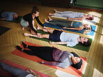 Yoga, personal trainer and men and women stretching in class for fitness, exercise and wellness in studio. Health club, pilates and instructor with group for flexibility workout, balance and training