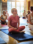 Yoga class, calm and woman for pilates exercise in zen studio gym for body, mind and spiritual balance. Fitness, calm and female person for meditation workout with group for health in community hall.