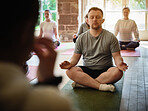 Lotus, yoga or man in class for meditation, breathing or healing in studio to relax for peace. Pilates instructor, group or healthy zen person on mat in calm pose for mindfulness or wellness together