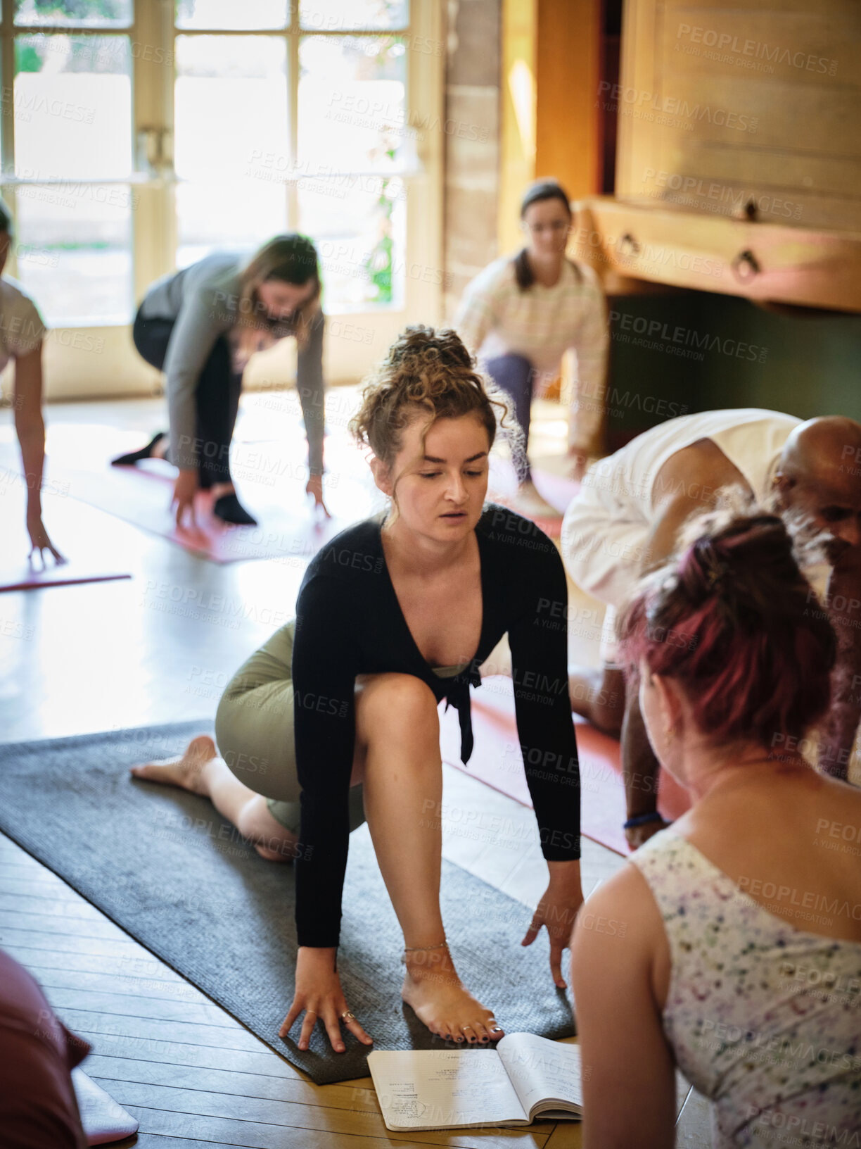 Buy stock photo Instructor, book or people learning in yoga class for meditation or body flexibility in zen studio. Woman teaching, start or pilates group stretching for balance, energy or wellness to relax together