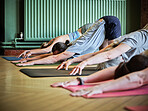 Group, people and stretching arms for yoga, workout and exercise in fitness centre or gym with mat. Wellness, men and woman with pilates, physical activity and training on floor of studio for balance