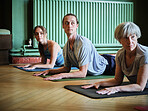 Group, yoga or people in class for meditation, breathing or body flexibility in zen studio for peace. Pilates club, group or healthy friends on mat in calm pose for mindfulness or wellness together
