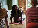 Group, people and yoga in class for stretching, workout or training with mindfulness and wellness. Pilates, women and dhanurasana on floor of gym or fitness center for exercise, balance and health