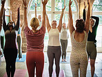 Group, people and stretching arms for yoga, workout and exercise in fitness centre or gym with mat. Wellness, zen and women with pilates, physical activity and training on floor of studio for balance