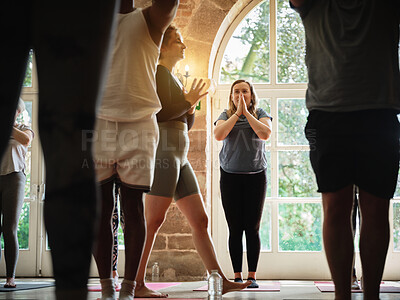 Buy stock photo Praying, instructor teaching or women in yoga class for meditation or mindfulness in zen studio. Coach, support or calm people in pilates club for chakra energy, aura or wellness to relax together