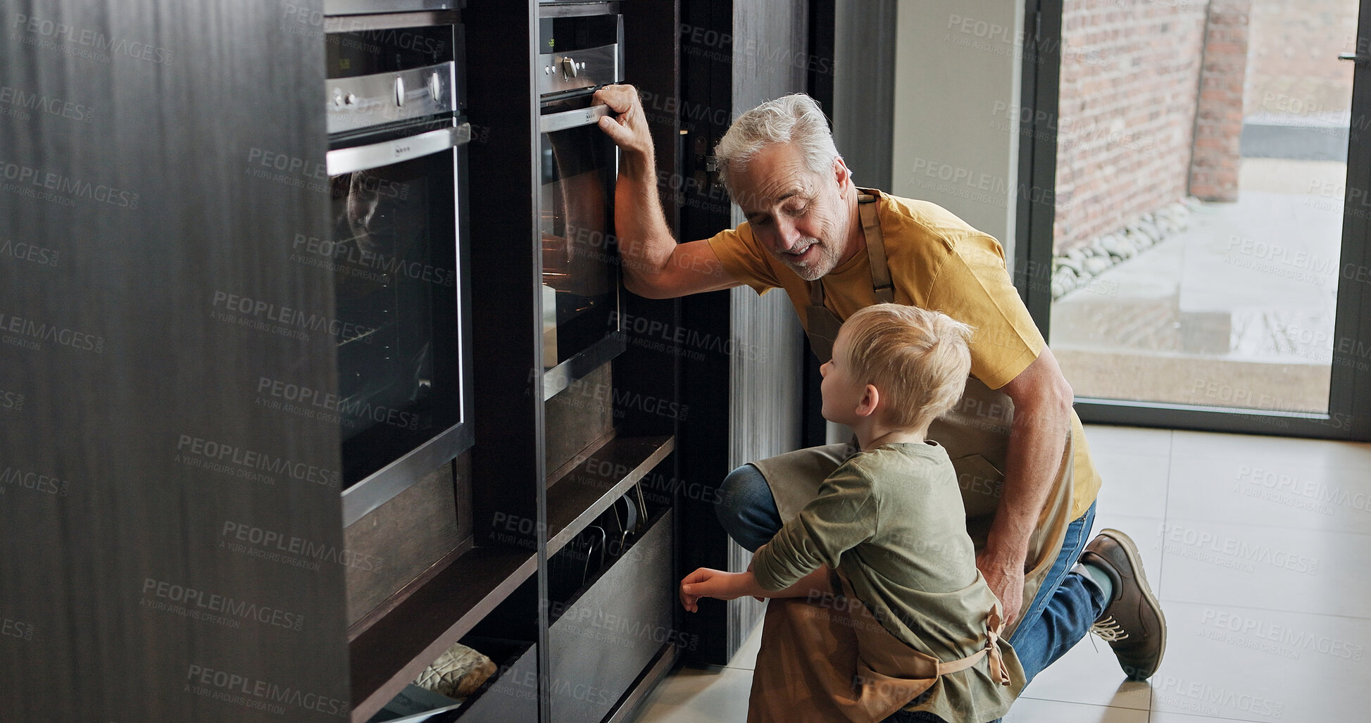 Buy stock photo Grandfather, kid and cooking at oven in kitchen, care and learning together in home. Happy grandpa, boy and child baking, waiting and love of family bonding, watching and prepare dessert in house