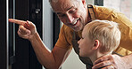 Grandfather, child and cooking at oven in kitchen, care and support or learning together in home. Happy grandpa, boy and kid baking, pointing and family waiting, bonding or smile for dessert in house