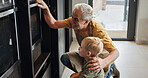 Grandpa, child and baking at oven in kitchen, care and support or learning together in home. Happy grandfather, boy and kid cooking, waiting and love of family bonding, watching and prepare dessert