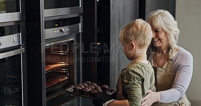Buy stock photo Grandmother, child and baking cupcakes at oven in kitchen, care and learning together in home. Happy grandma, boy and kid cooking muffins, love and family bonding, smile or prepare fresh dessert food