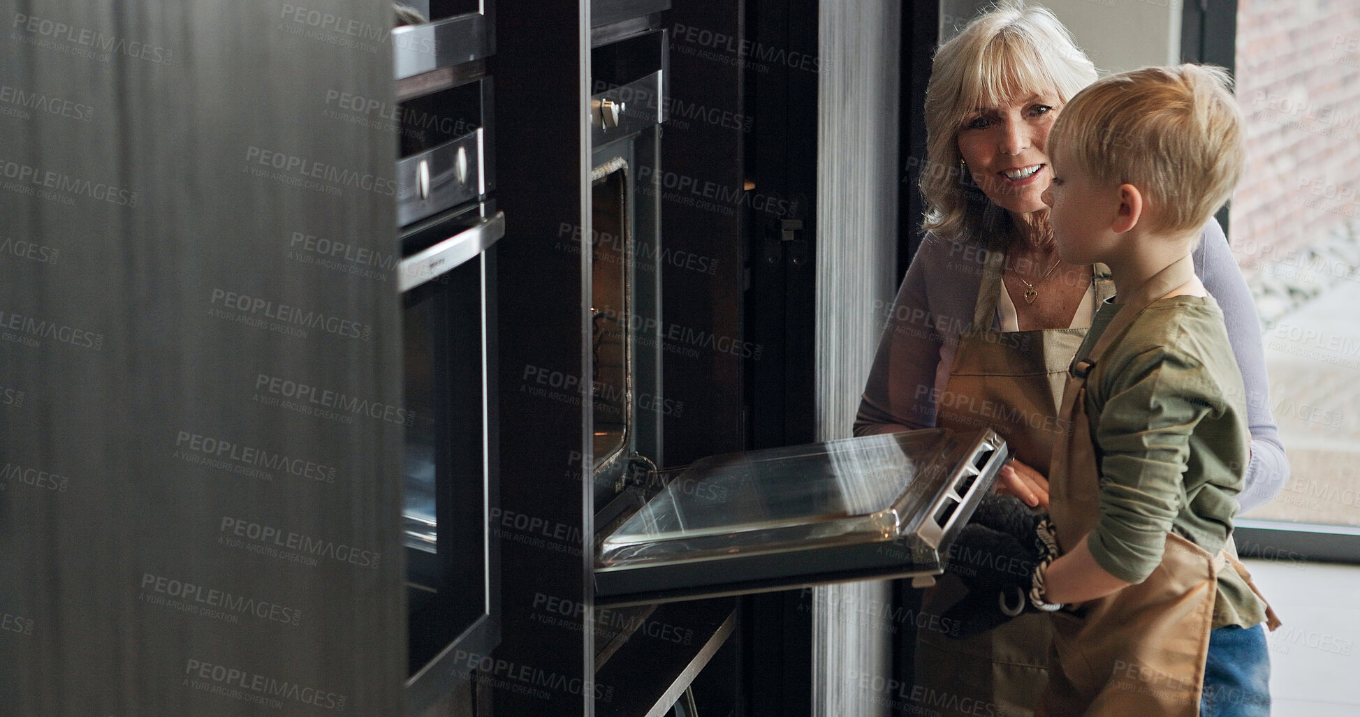 Buy stock photo Grandmother, child and baking at oven in kitchen, care and support or learning together in home. Happy grandma, boy and kid cooking, waiting and love of family bonding, smile and prepare dessert