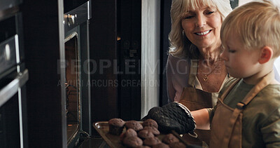 Buy stock photo Grandmother, kid and baking cupcakes at oven in kitchen, care and learning together in home. Happy grandma, boy and child cooking muffins, love and family bonding, smile or prepare fresh dessert food