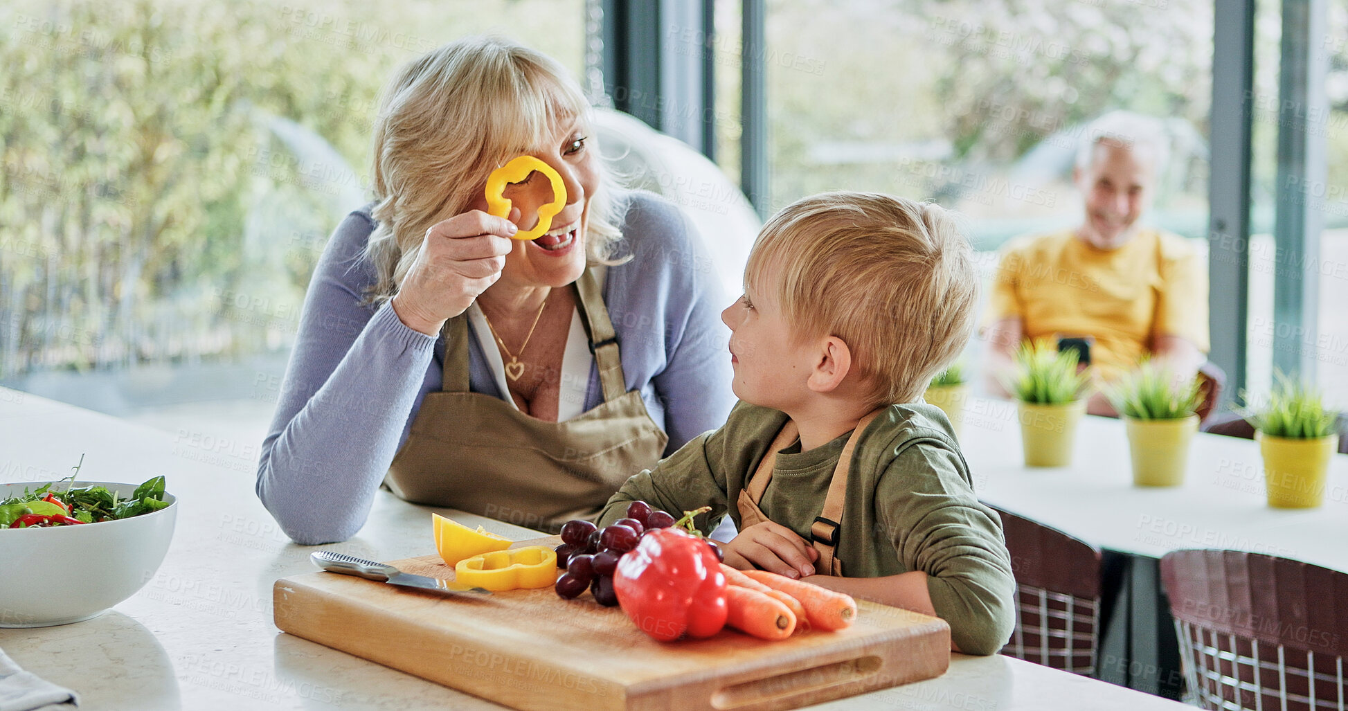 Buy stock photo Play, grandmother or child cooking for lunch, vegetables or nutrition with wellness in family home. Games, grandparents or happy kid with elderly grandma, smile or food for health, care or wellness