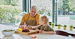 Senior man, child or nutrition in kitchen with teaching, relax wellness or discussion of healthy food. Grandfather, grandchild or learn of vegetables on weekend, together or care in modern apartment
