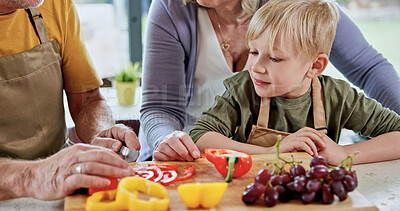 Buy stock photo Hands, grandparents or child cooking for lunch, vegetables or nutrition with love in family home. Fruits, senior grandfather or kid with elderly grandma, care or food for diet, teaching or learning