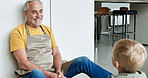 Floor, home and grandparent with child talking for bonding, relationship and relax on weekend. Retirement, family home and happy grandfather with young boy sitting for conversation, chat and speaking