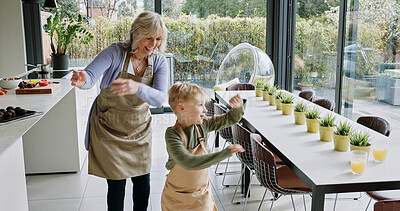 Buy stock photo Happy, dance and grandmother with child in kitchen with celebration, energy and bonding in home. Senior, woman and playing with kid for fun, games or moving together with rhythm, love and care